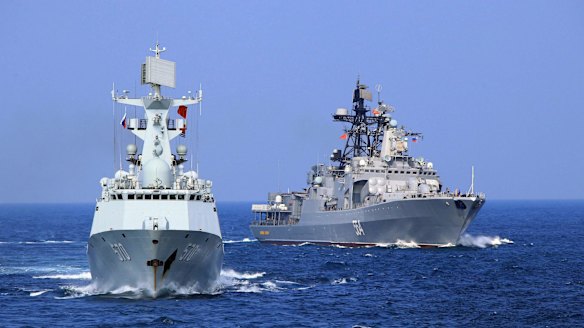 A Chinese Navy frigate and a Russian Navy ship take part in a joint naval drill in the South China Sea.