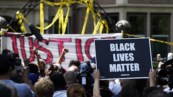 Protesters gather outside the governor's residence in Minnesota on Thursday.