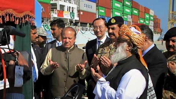 Pakistani Prime Minister Nawaz Sharif, centre left, prays near Chinese Ambassador to Pakistan Sun Weidong, centre after inaugurating a new international trade route during a ceremony at the Gwadar port.