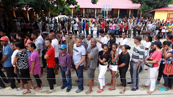 People queue up to give their vote during the presidential election at a polling station in Dili, East Timor,.