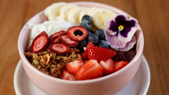 Acai bowl with banana, berries, coconut and granola.