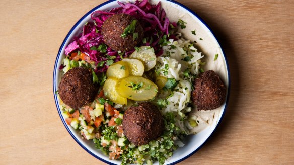 Red harissa falafel salad bowl.