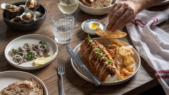 Curried fish finger roll with spicy pappadums at The Rover in Surry Hills.