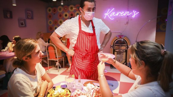 Supervisor Josh Arkey serves customers at Sydney's original Karen's Diner.