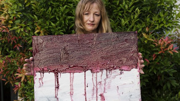 Sukumaran's painting teacher Tina Bailey holds a painting of the Indonesian flag dripping with blood, created on the day before his execution. 