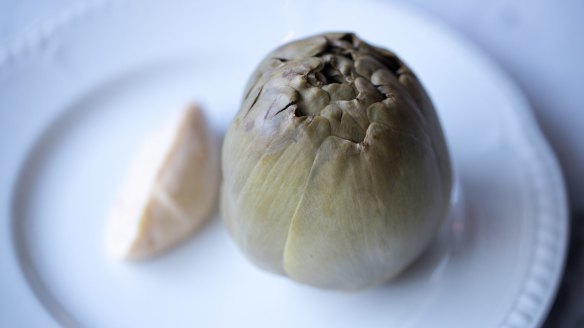 Boiled artichoke ready to be dissected and swished through bonito mayonnaise.