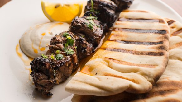 Skewered lamb rump with grilled flatbread and a squeeze of lemon.