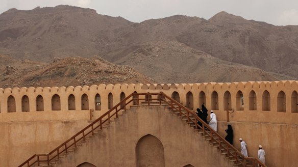 Omanis climb the wall of the Nizwa Fort, west of the capital Muscat. The fort was once Oman's seat of government.