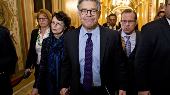 Senator Al Franken, flanked by his wife Franni Bryson, arrives in the US Capitol to announce his resignation. 