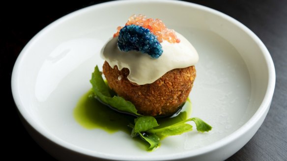 Spanner-crab rice ball with scampi caviar, finger lime, sate oil and oyster emulsion.