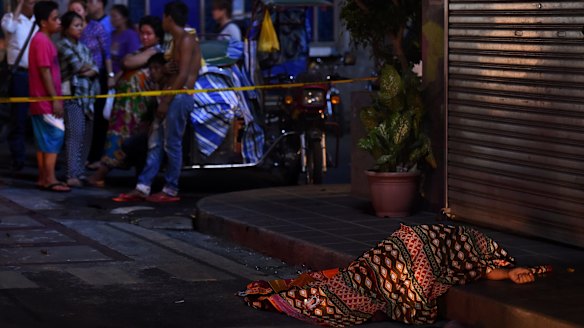 One of two people killed in a double shooting in the Manila suburb of Baclaran is left lying in the street. 