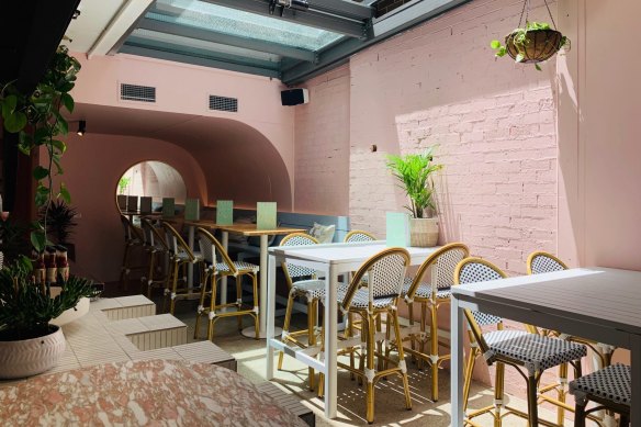 The dusty pink walls are reminiscent of the pastel homes of Charleston's historic waterfront.