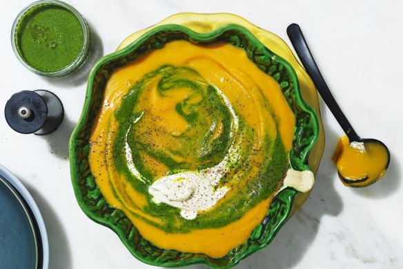 Roast pumpkin soup swirled with spinach puree and cream.