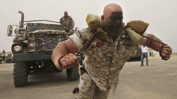 A Lebanese commando pulls an armoured truck at this month's Security Middle East Shows in Beirut.