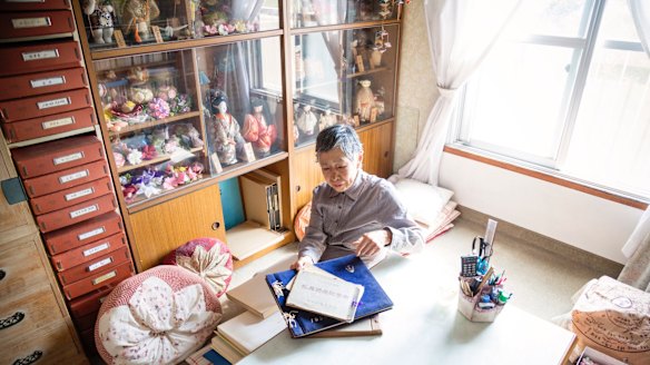 Chieko Ito puts away photo albums in her apartment. She has made sure her worldly affairs are entirely organised in the event of her death.