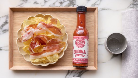 Finely shaved Iberian paleta with truffled crisps and a little bottle of hot sauce.