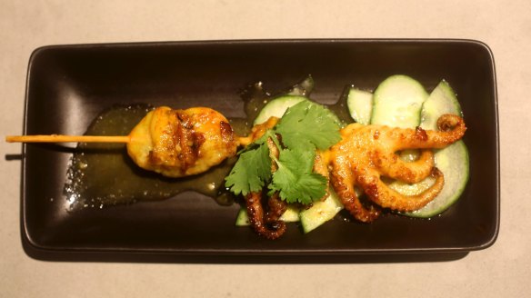 Grilled marinated baby octopus skewer with nahm jim sauce.