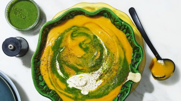 Roast pumpkin soup swirled with spinach puree and cream.
