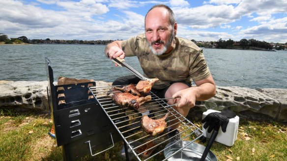 BBQAroma owner Nick Angelucci cooking on his portable Ferraboli picnic grill in a Leichhardt park.