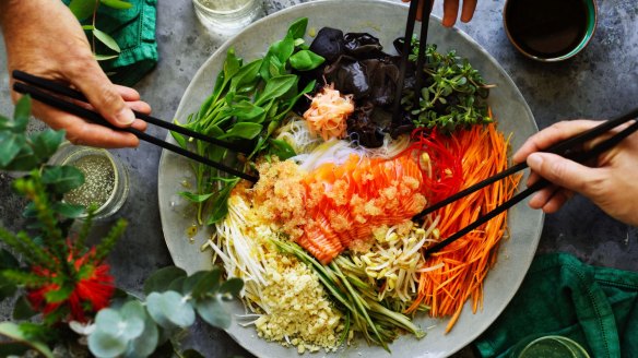 Chinese New Year good luck salad is tossed together at the table.