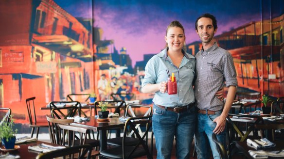 Owner Alicia Ingram and manager Mitch Liehr in the new Bourbon Street Kitchen, in front of the mural by street artist Byrd.