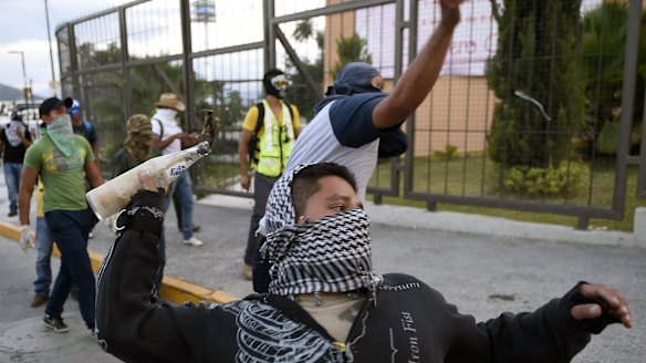 Students from the Ayotzinapa school take part in a protest demanding for justice.