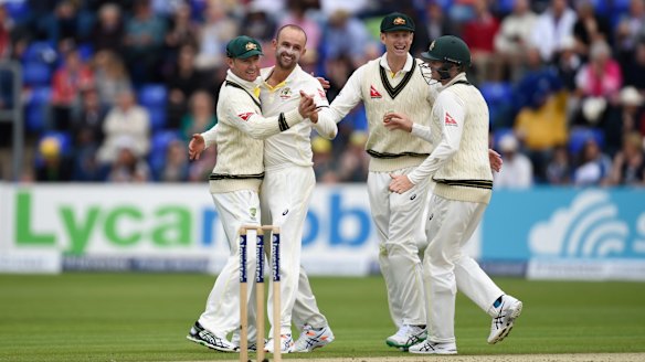 Celebration: Nathan Lyon enjoys the wicket of Alastair Cook with teammates.