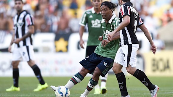 Veteran star: Ronaldinho controls the ball during a match for Fluminense against Atletico Mineiro in the Brasileirao Series A last August.