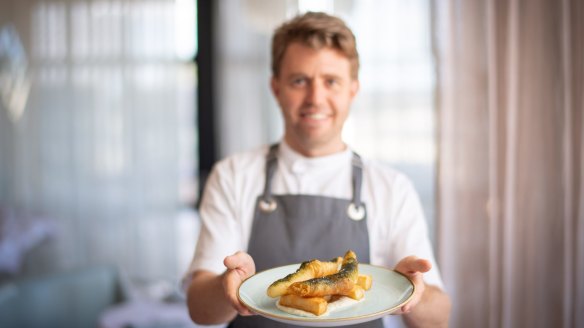 Executive chef Jason Staudt at the Stokehouse with the St Kilda restaurant's signature fish and chips. 