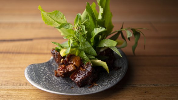Sticky aged pork surrounded by fresh Thai herbs and leaves. 