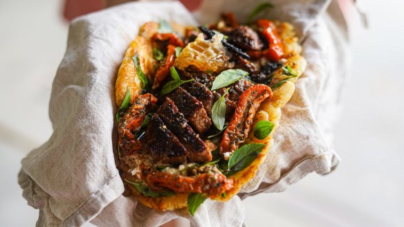 Flatbread loaded with coffee spice-rubbed lamb with honey and feta.