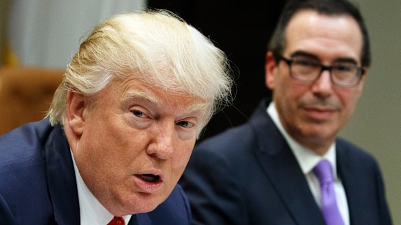 Treasury Secretary Steven Mnuchin listens at right as President Donald Trump speaks during a meeting on the Federal budget last month.