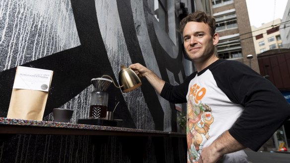 Manager of Single O Dan Winch pouring the cafe's new $20 coffee at its outdoor coffee bar.