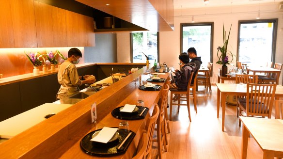 Yakitori Bar is a clean, serene room with chefs in action behind the main counter.