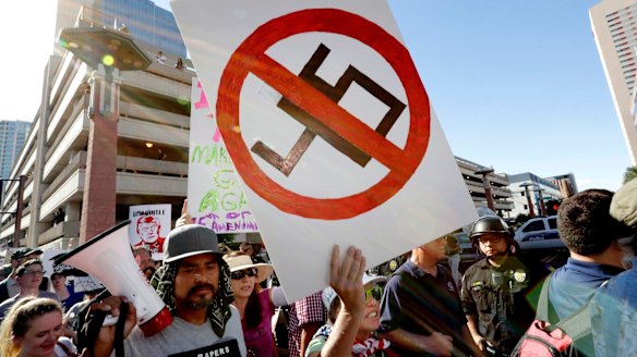 Protesters outside the convention centre while  Trump delivers his campaign-style speech inside.