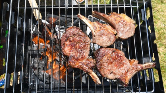 Steak and chops cooked over charcoal outdoors by Nick Angelucci.