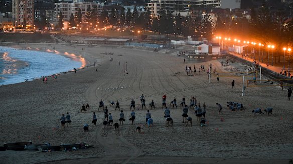 Bathers on Coogee Beach early on Friday before scorching weather sets in over NSW.