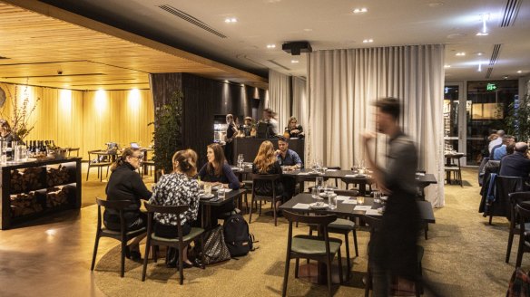 Corporate-chic: Grey curtains divide the dining room.