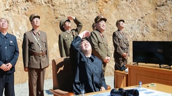 A video of a news bulletin aired by North Korea's KRT on Tuesday shows what was said to be North Korea leader Kim Jong-un (centre) watching the launch.