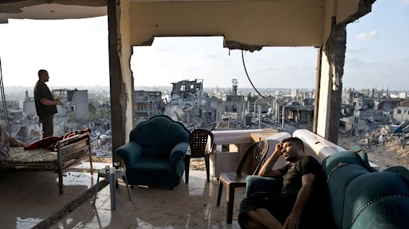 Adel (right) and Mohammed spend the afternoon in the only room of their home not totally destroyed after an Israeli missile in 2014.