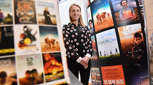 Olivia Humphrey, founder and CEO of Kanopy, with some of the titles available through her streaming service. 