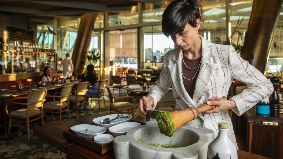 a'Mare manager Alice Perini preparing the pesto tableside for the trofie al pesto dish.