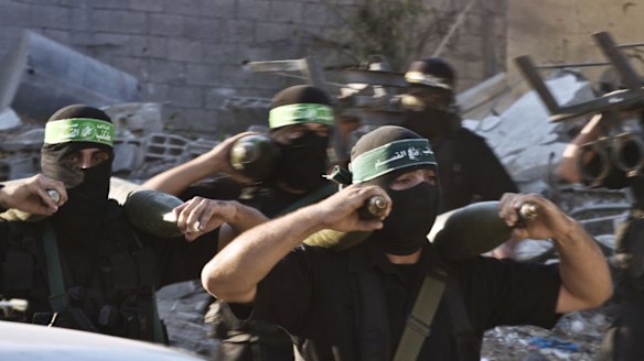 Hamas militants carry mortar rounds in August 2014. 