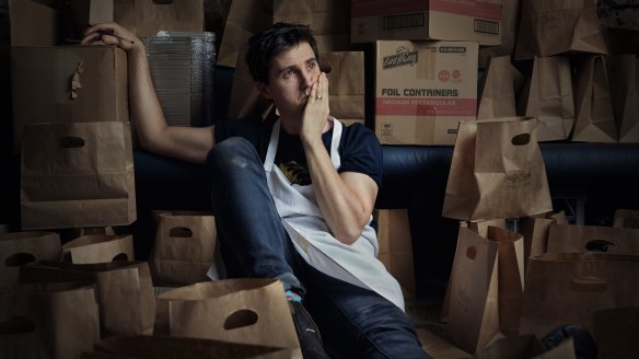 Josh Niland surrounded by takeaway packaging at Saint Peter restaurant in Sydney.