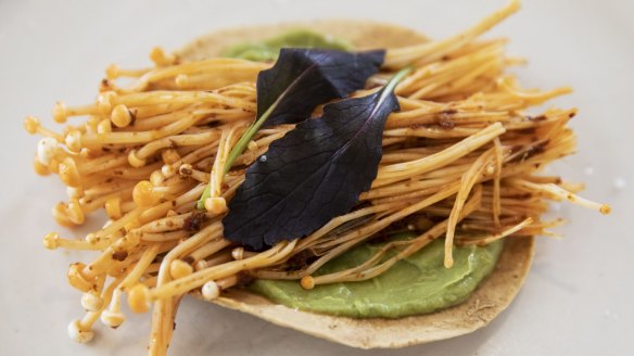 Tostadas with enoki mushrooms, avocado puree and black garlic XO sauce.