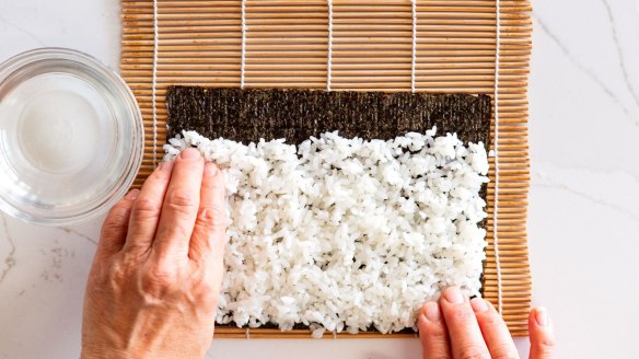 Step-by-step sushi rolls.
Step 1. Place noriÃÂÃÂ sheet, smooth side down, on a sushi rolling mat and cover with rice, leaving a 2cm border on the side furthest from you.
Pic credit: Nagi Maehashi
For Good Food, April 26, 2022