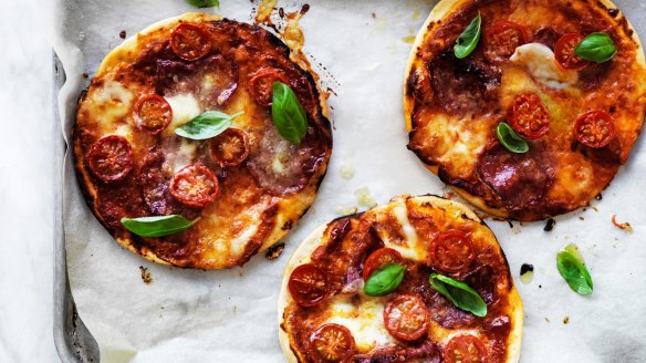 Making and topping mini pizzas is fun for the whole family.