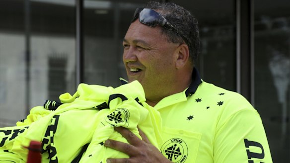 Lomax with specially designed T-shirts outside the ACT Magistrates Court.