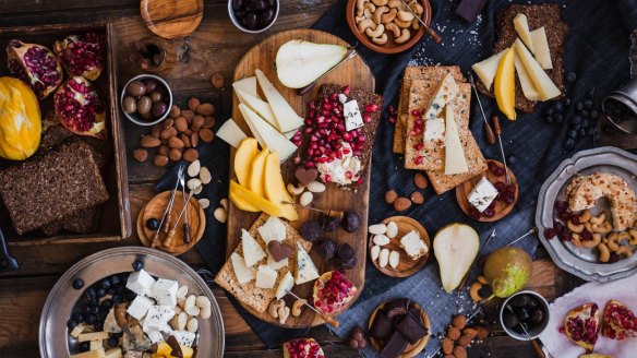 Displaying cheese in slices with fruits and nuts is equally pretty and practical for grazing guests.