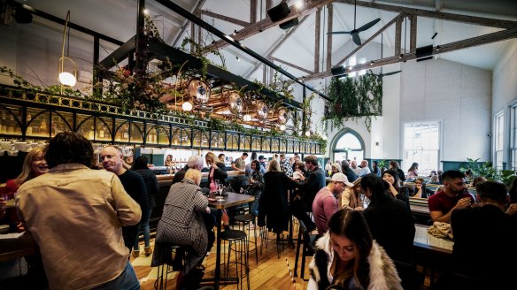 The hall's original features including hardwood ceiling trusses and arched doors have been preserved.